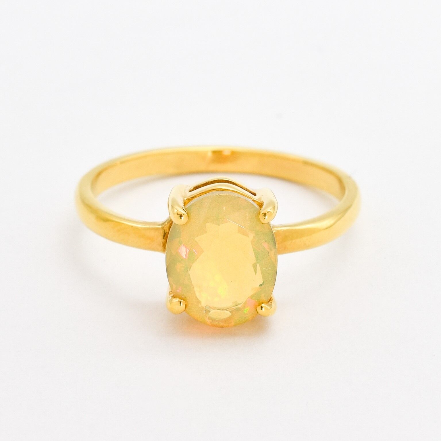 Natural Fire Opal solitaire design in yellow gold setting radiating warmth and positivity perfect as an October birthstone gift for engagements anniversaries, promise ring or milestone celebrations.