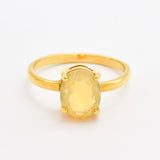 Natural Fire Opal solitaire design in yellow gold setting radiating warmth and positivity perfect as an October birthstone gift for engagements anniversaries, promise ring or milestone celebrations.