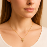 Woman wearing a Dainty Real Diamond Cross Necklace set in Solid 14k Yellow Gold. April birthstone in round cut, and stunning clarity, and in a prong setting. Symbolizing purity, and inner strength, ideal to wear on special occasions especially religious activities.