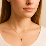 Woman wearing a Dainty Real Diamond Cross Necklace set in Solid 14k Yellow Gold. April birthstone in round cut, and stunning clarity, and in a prong setting. Symbolizing purity, and inner strength, ideal to wear on special occasions especially religious activities.
