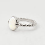 White Opal bubble band solitaire ring in solid 925 sterling silver with rainbow and fire color flashes, offering calming energy and emotional balance, perfect as an October birthstone gift and can be gifted on engagements, anniversaries, or milestone celebrations.