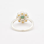 Natural Emerald and Opal Flower Ring in sterling silver with round cabochon opals surrounding a central emerald. Jewelry style is elegant, floral, and artistic with a timeless silver band. Emerald is linked to growth, renewal, and love while Opal is believed to inspire creativity and balance. A meaningful May or Birthstone birthstone gift for birthdays, anniversaries, or special celebrations. Ideal for weddings, garden parties, formal gatherings, or daily elegance.