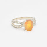 Ethiopian Opal Oval Ring in sterling silver with a 4 prong setting and split shank design. Jewelry style features a CZ pave band that adds brilliance around the opal gemstone, glowing with flashes of fire colors. Opal is known for inspiring creativity, passion, and emotional balance. A meaningful October birthstone gift for birthdays, anniversaries, and special milestones. Perfect to wear at weddings, evening dinners, formal events, and cocktail parties.