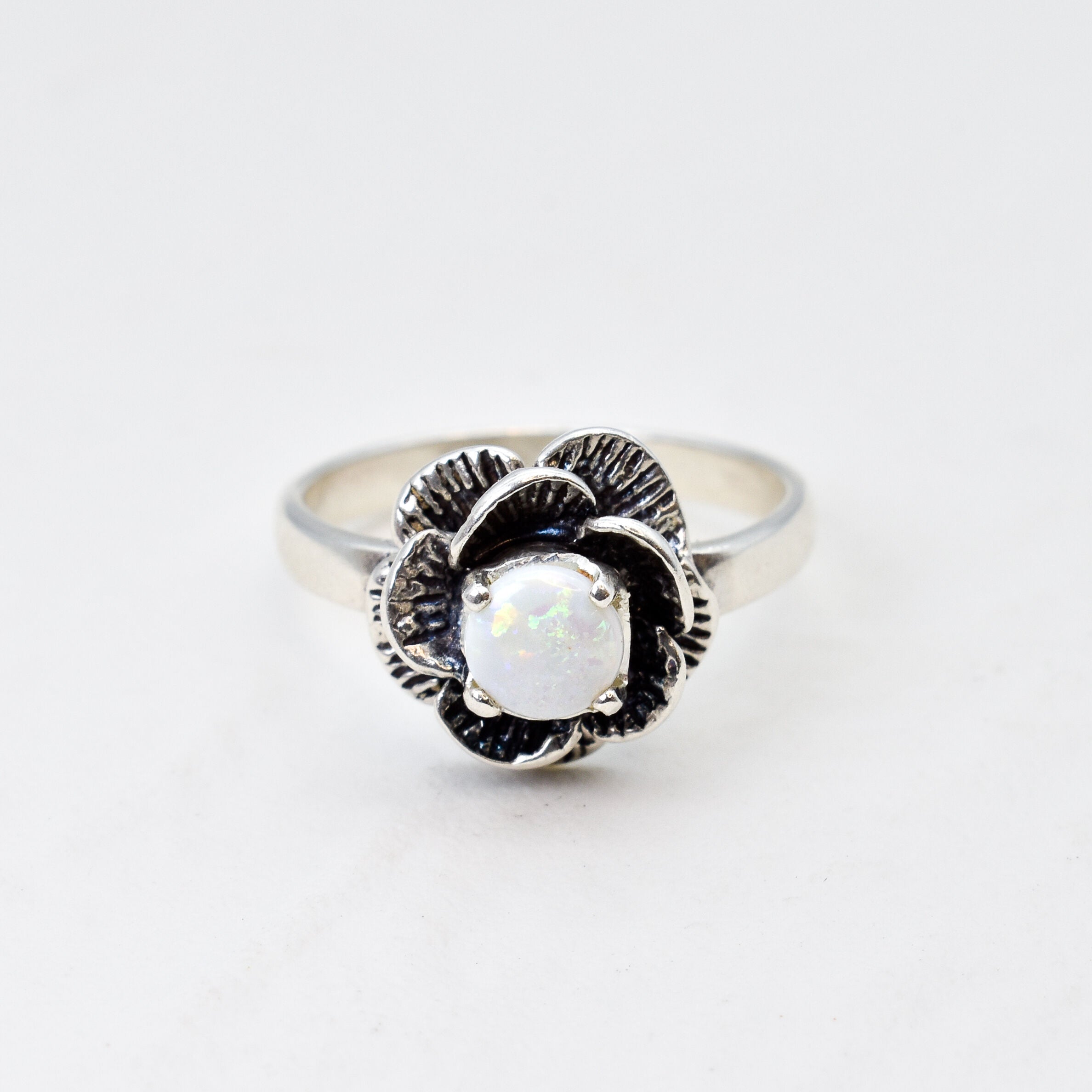 Natural Opal Flower design set in sterling silver ring offering timeless elegance and calming energy perfect as an October birthstone gift for birthdays anniversaries or romantic proposals.