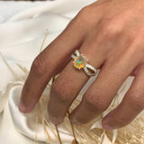 Opal Oval Ring paired with minimalist accessories. Jewelry style is classic and modern with a split shank sterling silver band, CZ pave details, and a 4 prong oval gemstone. The opal glows with flashes of fire colors, symbolizing creativity and passion. A thoughtful gift for anniversaries or birthdays. Perfect for special dinners, parties, or everyday elegance.