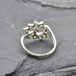 Opal Spiral Ring in sterling silver designed as a sunburst swirl statement jewelry piece offering radiant flashes of fire colors and boho charm, believed to inspire creativity and positivity, making it a thoughtful October birthstone gift idea. Perfect to wear at weddings, parties, and special occasions for a vibrant standout look.