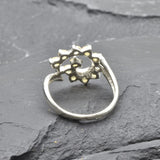 Opal Spiral Ring in sterling silver designed as a sunburst swirl statement jewelry piece offering radiant flashes of fire colors and boho charm, believed to inspire creativity and positivity, making it a thoughtful October birthstone gift idea. Perfect to wear at weddings, parties, and special occasions for a vibrant standout look.