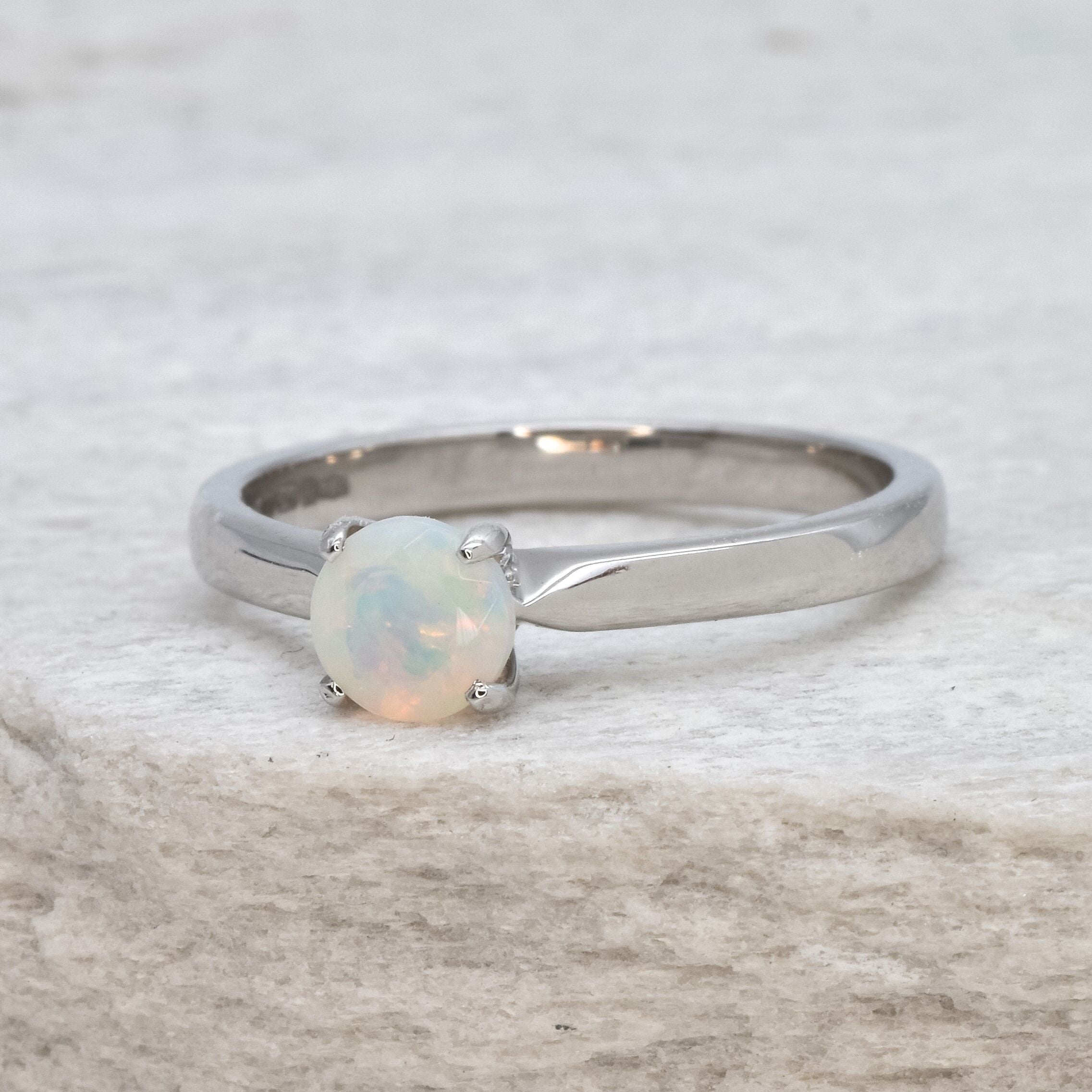 Natural Fire Opal solitaire ring set in 18k solid white gold, a timeless jewelry piece symbolizing creativity and passion, the perfect October birthstone gift for anniversaries, engagements, or milestone celebrations.