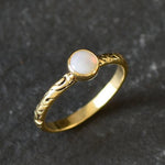Bezel Opal ring with engraved gold band in a tribal boho style. The opal displays fire colors and flashing rainbow tones, symbolizing hope, creativity and emotional balance. A unique October birthstone gift perfect for anniversaries, festivals, weddings and special celebrations.