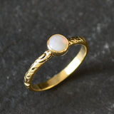 Bezel Opal ring with engraved gold band in a tribal boho style. The opal displays fire colors and flashing rainbow tones, symbolizing hope, creativity and emotional balance. A unique October birthstone gift perfect for anniversaries, festivals, weddings and special celebrations.