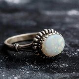 Australian Opal Ring in sterling silver with a horizontal oval cabochon design, white stone showing flashes of fire colors, delicate jewelry style for everyday elegance, meaningful October birthstone gift idea. Perfect for weddings, anniversaries, cocktail parties, and milestone events.