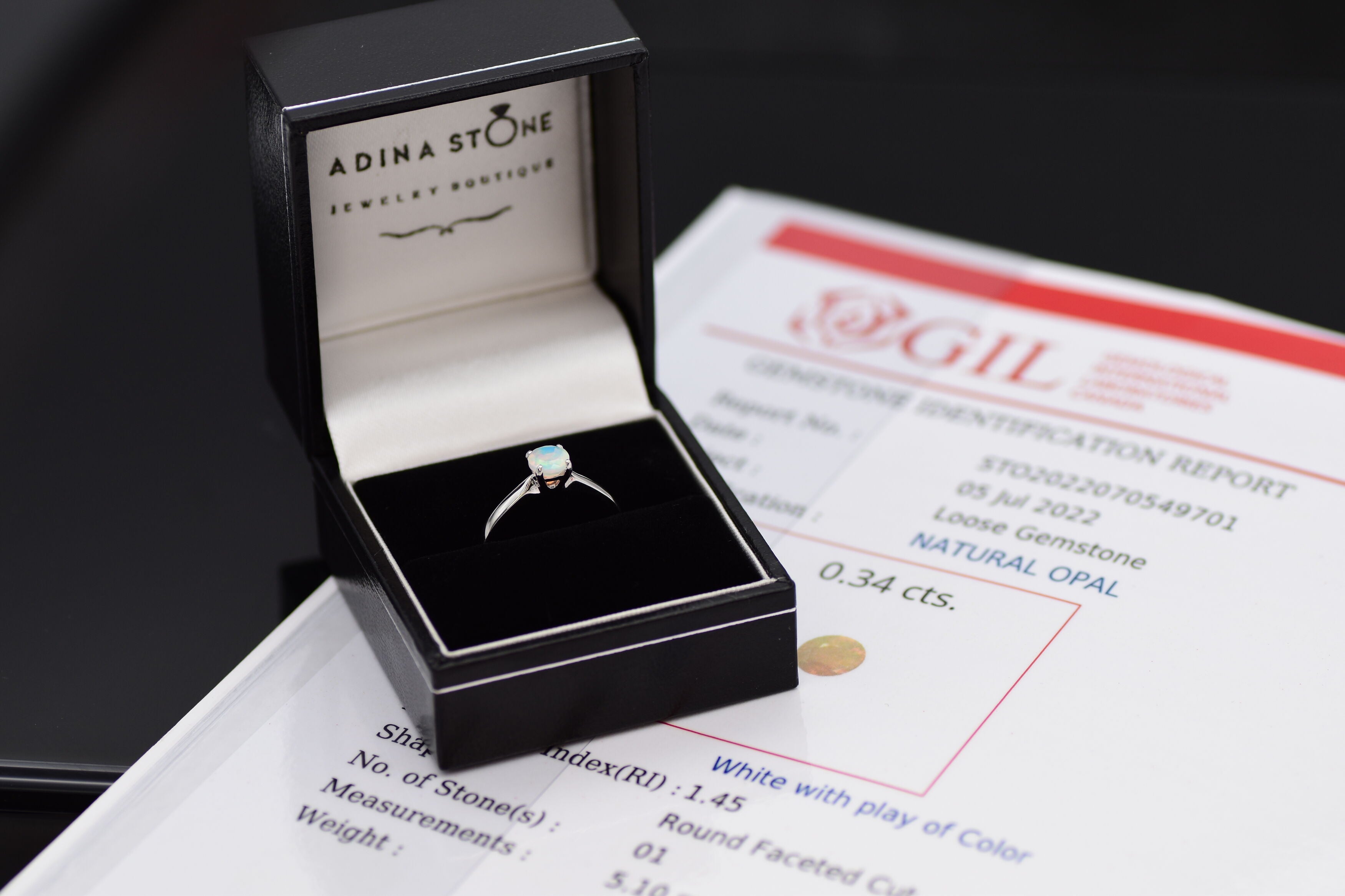 Natural Fire Opal solitaire ring set in 18k solid white gold, a timeless jewelry piece symbolizing creativity and passion, the perfect October birthstone gift for anniversaries, engagements, or milestone celebrations.