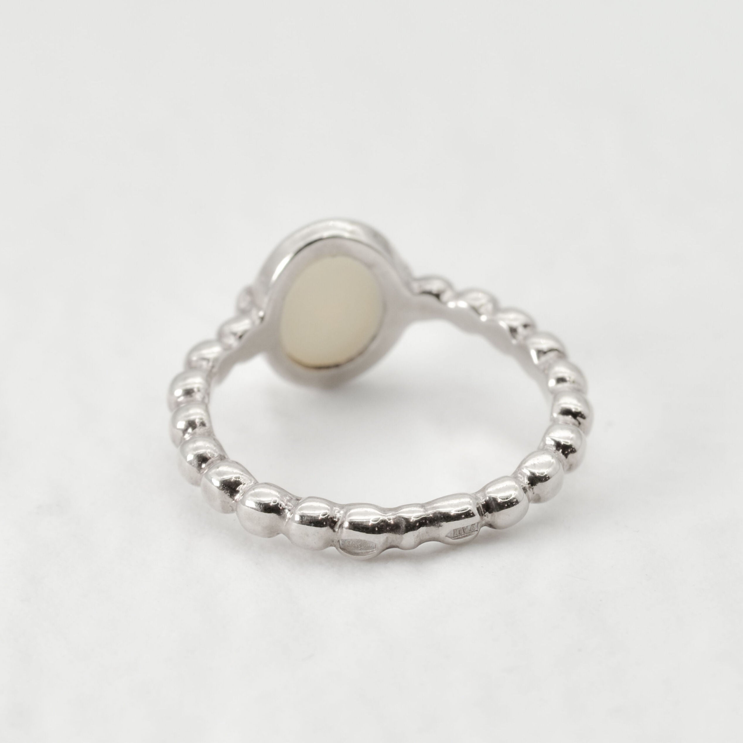 White Opal bubble band solitaire ring in solid 925 sterling silver with rainbow and fire color flashes, offering calming energy and emotional balance, perfect as an October birthstone gift and can be gifted on engagements, anniversaries, or milestone celebrations.
