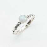 White Opal Bezel Ring with engraved tribal inspired silver band. The dainty minimalist design highlights the gemstone with flashes of color, making it both elegant and unique. Opal is known to bring inspiration, harmony, and emotional balance. A thoughtful promise ring or October birthstone gift for birthdays, anniversaries, and special milestones. Perfect to wear daily or for boho chic events, weddings, and family gatherings.