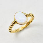 White Opal bubble band solitaire ring in 18k gold vermeil with rainbow and fire color flashes, offering calming energy and emotional balance, perfect as an October birthstone gift and can be gifted on engagements, anniversaries, or milestone celebrations.