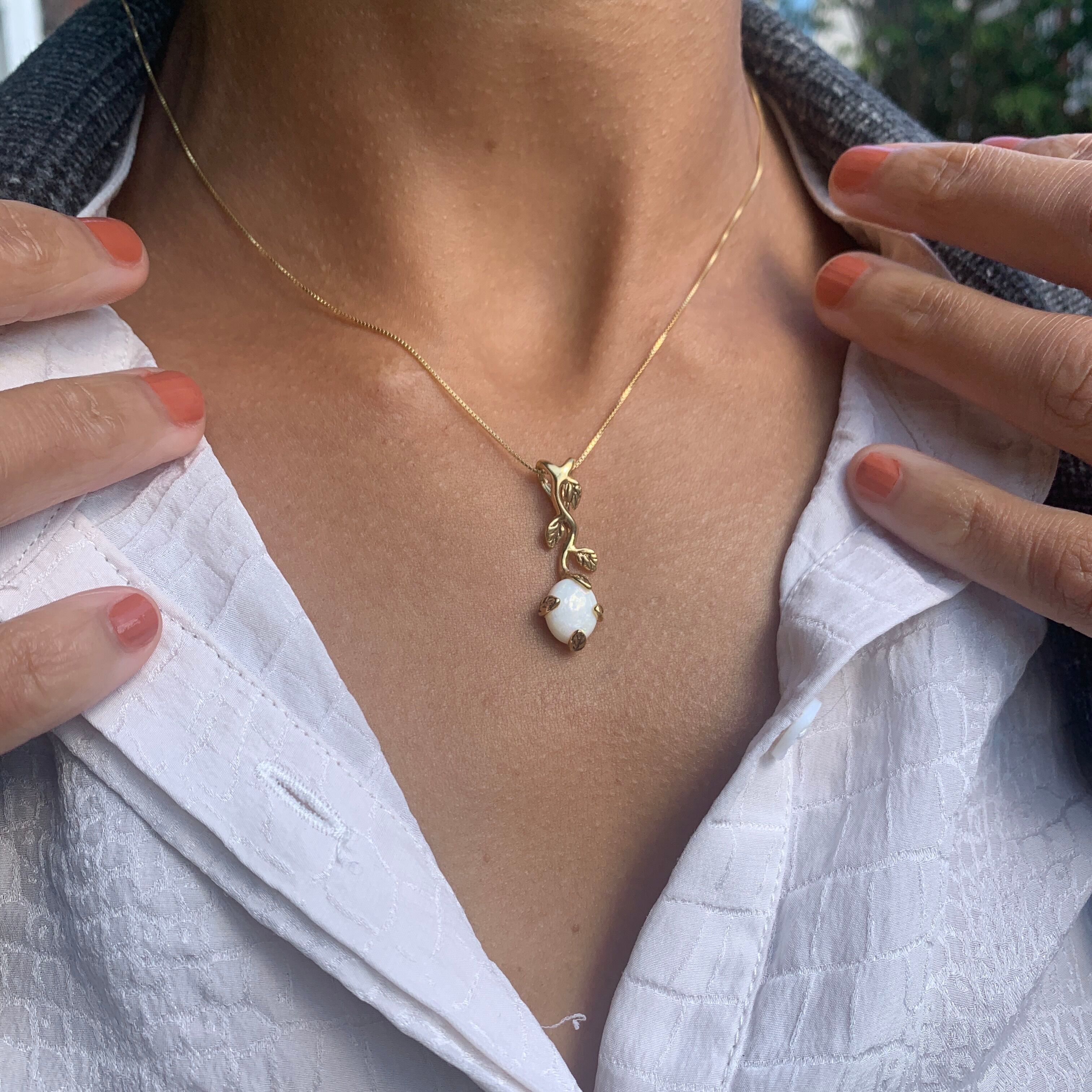 Opal pendant that inspires emotional healing and self-reflection