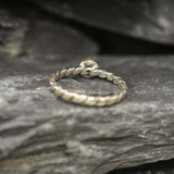 White Opal bezel solitaire ring with round cut stone and twisted band in sterling silver, a timeless jewelry style that highlights flashes of fire colors and durability. Offers the benefit of a secure bezel setting with a refined solitaire look, making it a meaningful October birthstone gift idea. Perfect for birthdays, anniversaries, engagements, and daily wear events.