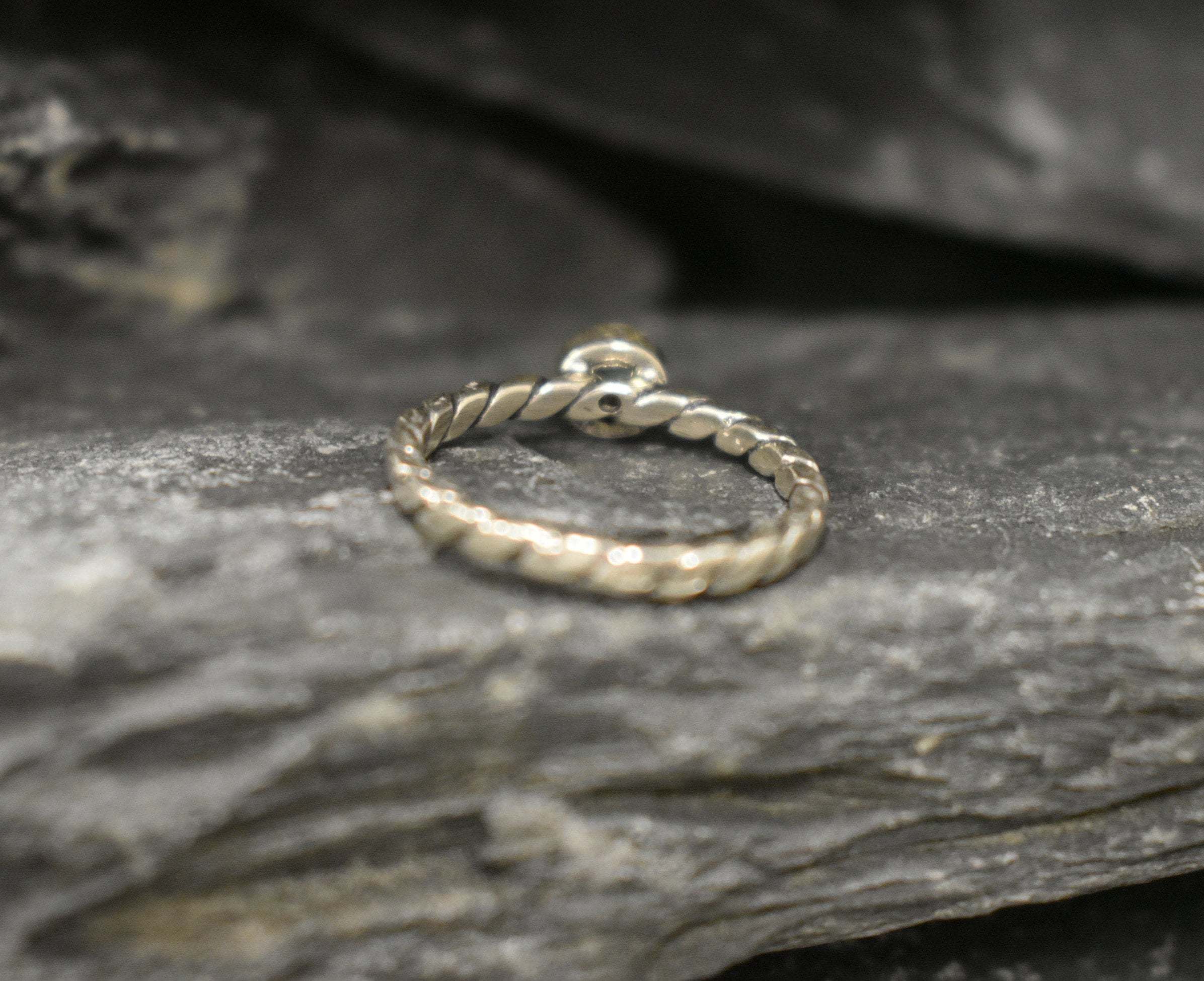 White Opal bezel solitaire ring with round cut stone and twisted band in sterling silver, a timeless jewelry style that highlights flashes of fire colors and durability. Offers the benefit of a secure bezel setting with a refined solitaire look, making it a meaningful October birthstone gift idea. Perfect for birthdays, anniversaries, engagements, and daily wear events.