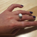 White Australian Opal Ring styled on middle finger with glossy purple manicure, horizontal cabochon cut with subtle fire flashes, elegant October birthstone jewelry that adds charm and balance. Ideal for date nights, gallery visits, and social gatherings