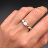 White Opal Bezel Ring worn on middle finger with bare nails, perfect for enhancing calmness and creativity, suited for weekend get-togethers or casual brunch dates.