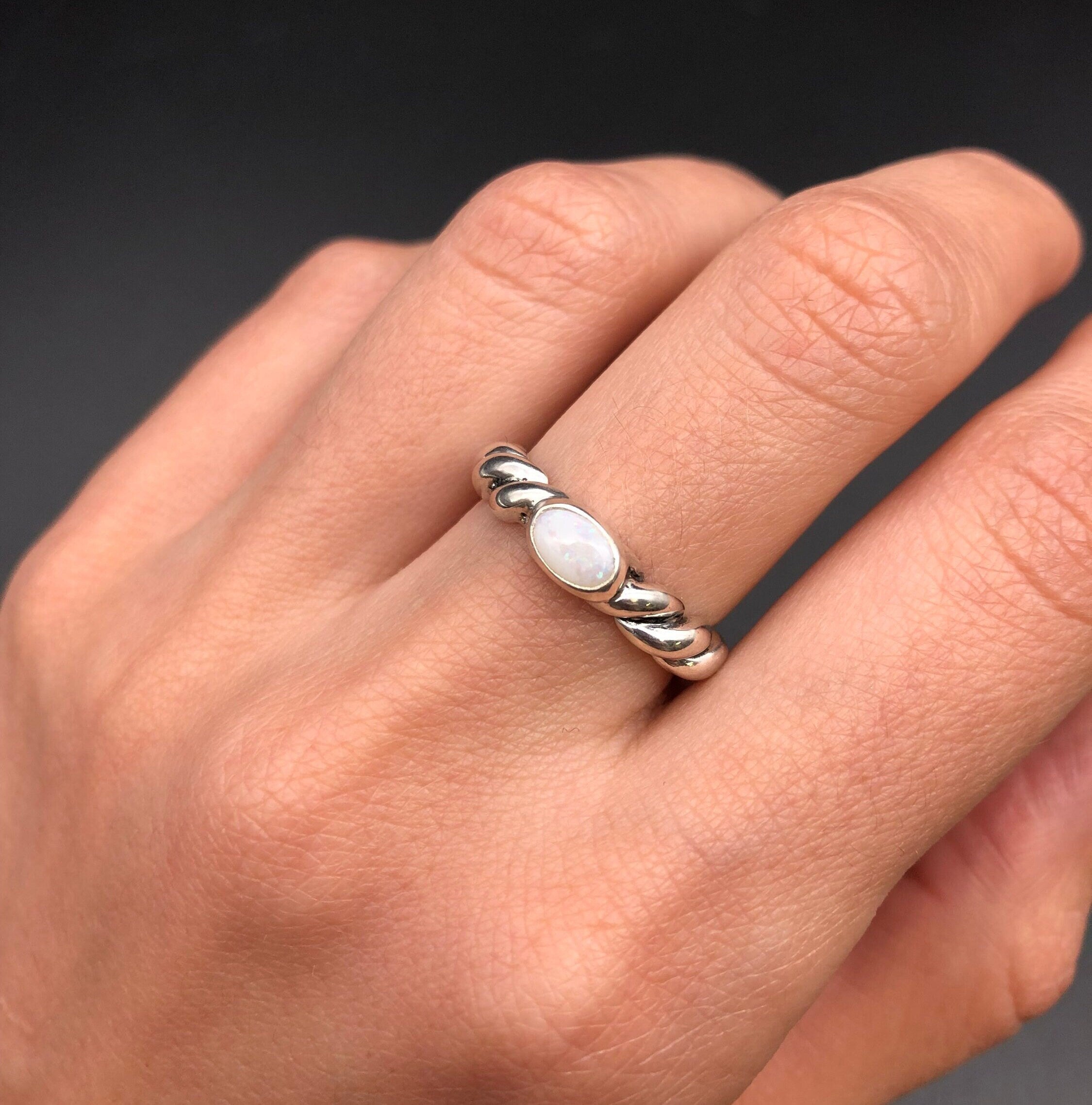 White Opal Bezel Ring worn on middle finger with bare nails, perfect for enhancing calmness and creativity, suited for weekend get-togethers or casual brunch dates.