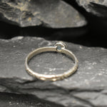 White Opal Bezel Ring with engraved tribal inspired silver band. The dainty minimalist design highlights the gemstone with flashes of color, making it both elegant and unique. Opal is known to bring inspiration, harmony, and emotional balance. A thoughtful promise ring or October birthstone gift for birthdays, anniversaries, and special milestones. Perfect to wear daily or for boho chic events, weddings, and family gatherings.