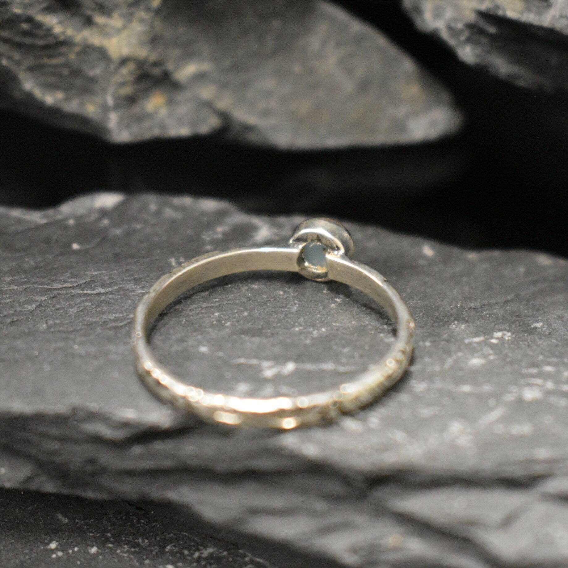 White Opal Bezel Ring with engraved tribal inspired silver band. The dainty minimalist design highlights the gemstone with flashes of color, making it both elegant and unique. Opal is known to bring inspiration, harmony, and emotional balance. A thoughtful promise ring or October birthstone gift for birthdays, anniversaries, and special milestones. Perfect to wear daily or for boho chic events, weddings, and family gatherings.