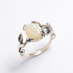 White Opal cabochon vine and leaf ring crafted in solid 925 sterling silver, featuring a nature-inspired design with flashes of fire colors. The durable vine-style band offers elegance and uniqueness while remaining comfortable for daily wear. As the October Birthstone, White Opal makes a thoughtful gift for birthdays, anniversaries, and nature lovers. Perfect to wear at weddings, outdoor celebrations, and festive gatherings.