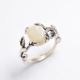 White Opal cabochon vine and leaf ring crafted in solid 925 sterling silver, featuring a nature-inspired design with flashes of fire colors. The durable vine-style band offers elegance and uniqueness while remaining comfortable for daily wear. As the October Birthstone, White Opal makes a thoughtful gift for birthdays, anniversaries, and nature lovers. Perfect to wear at weddings, outdoor celebrations, and festive gatherings.