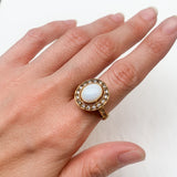 Natural Opal ring in gold with a halo of sparkling diamonds, featuring a cabochon cut gemstone for an elegant and timeless style. Known for promoting creativity and emotional balance, Opal is the October birthstone and makes a thoughtful gift for birthdays, anniversaries, weddings, or milestone celebrations.
