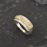 Opal Row Half Eternity Wide Ring in sterling silver featuring natural fire opals with flashes of fire colors, accented by CZ pave for a bold jewelry style. A meaningful October birthstone piece symbolizing balance and inspiration, making it a treasured gift idea. Perfect for weddings, anniversaries, cocktail events, and elegant evening occasions.