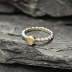 Yellow Fire Opal Bubble Band Ring in sterling silver with bezel set round cut, showcasing flashes of fire colors in a tennis band design for an elegant jewelry style. This durable and timeless piece is a meaningful October birthstone gift idea, symbolizing passion and inspiration. Ideal for birthdays, weddings, anniversaries, and evening occasions where a touch of unique brilliance is desired.