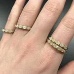 Yellow Ethiopian Fire Opal half eternity band ring in sterling silver with diamond cut stones set in a row, showcasing flashes of fire colors in a dainty jewelry style. Offers the benefit of a sleek eternity design with bright opals for durability and charm, making it a meaningful October birthstone gift. Perfect for weddings, anniversaries, birthdays, and daily wear.