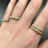 Yellow Ethiopian Fire Opal half eternity band ring in sterling silver with diamond cut stones set in a row, showcasing flashes of fire colors in a dainty jewelry style. Offers the benefit of a sleek eternity design with bright opals for durability and charm, making it a meaningful October birthstone gift. Perfect for weddings, anniversaries, birthdays, and daily wear.