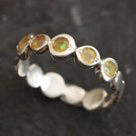 Yellow Ethiopian Fire Opal bezel tennis band eternity ring in sterling silver with diamond cut stones showing flashes of fire colors, a stylish jewelry design with bubble band details. Provides the benefit of a secure bezel setting and continuous gemstone glow, making it a meaningful October birthstone gift. Perfect for weddings, anniversaries, birthdays, and everyday wear.