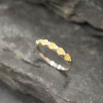 Yellow Ethiopian Fire Opal half eternity band ring in sterling silver with diamond cut stones set in a row, showcasing flashes of fire colors in a dainty jewelry style. Offers the benefit of a sleek eternity design with bright opals for durability and charm, making it a meaningful October birthstone gift. Perfect for weddings, anniversaries, birthdays, and daily wear.