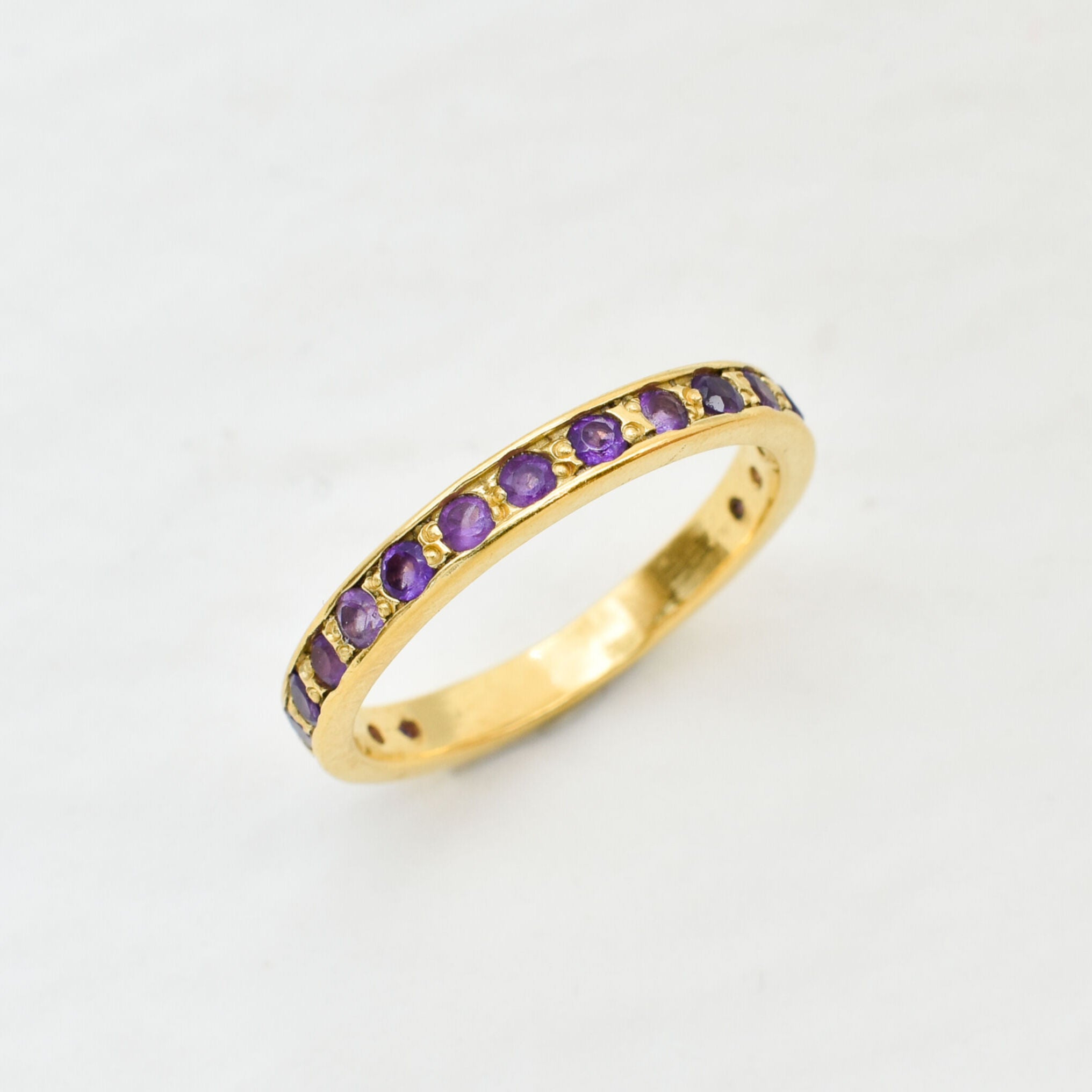 Amethyst gold ring with 1 carat total diamond cut purple stones on polished gold band