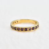 Front view of amethyst gold ring showcasing sparkling purple diamond cut stones
