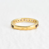 Side view of amethyst gold ring highlighting diamond cut stones and polished gold band