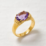 Gold ring featuring diamond cut natural amethyst stone in classic polished band