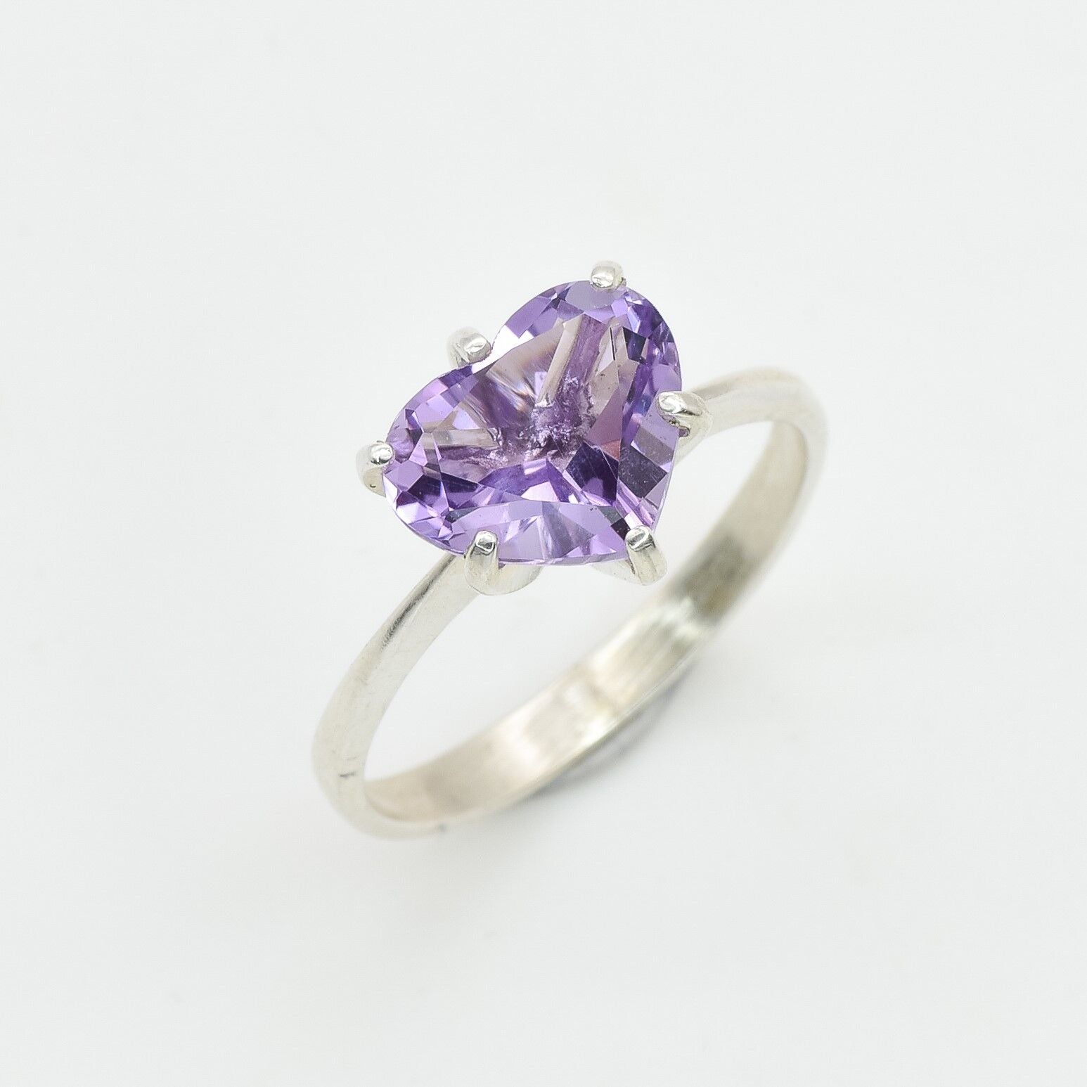 Sterling silver amethyst heart ring featuring an 8mm heart-shaped natural gemstone with diamond cut clarity