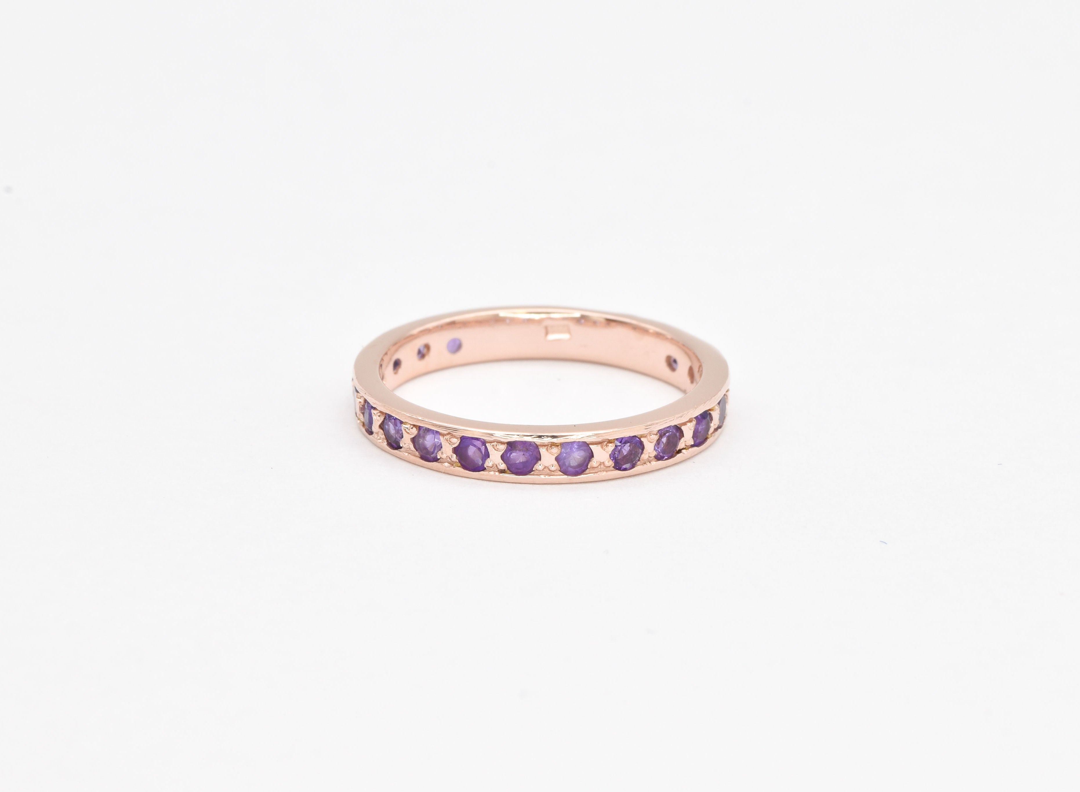 Rose gold amethyst ring with diamond cut purple stones for a vintage look