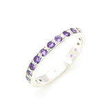 Side view of amethyst gold ring highlighting diamond cut stones and polished gold band