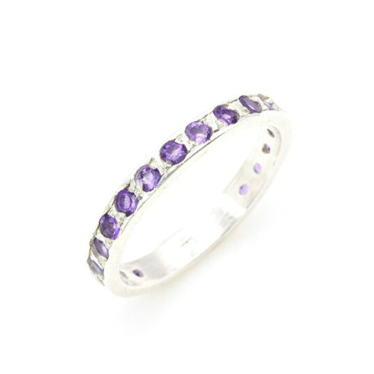 Side view of amethyst gold ring highlighting diamond cut stones and polished gold band