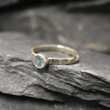 Sleek hammered silver band with Aquamarine, offering a minimalist style and thoughtful birthday gesture.