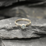 Minimalist hammered band with cool blue Aquamarine, perfect for work looks or calming benefits.