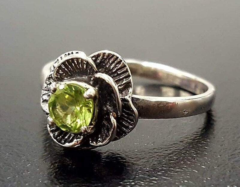 Sterling Silver ring with Peridot center, known for emotional healing, a charming gift for August birthdays or garden parties.