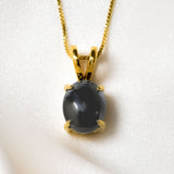 Natural Black Hematite necklace in 18k yellow gold over solid 925 sterling silver, in a cabochon cut, and prong setting. Solitaire gemstone perfect as a power statement necklace for formal wear and special occasions. Hematite symbolizes grounding, protection, and stability, making it a powerful stone for enhancing mental clarity and emotional well-being.