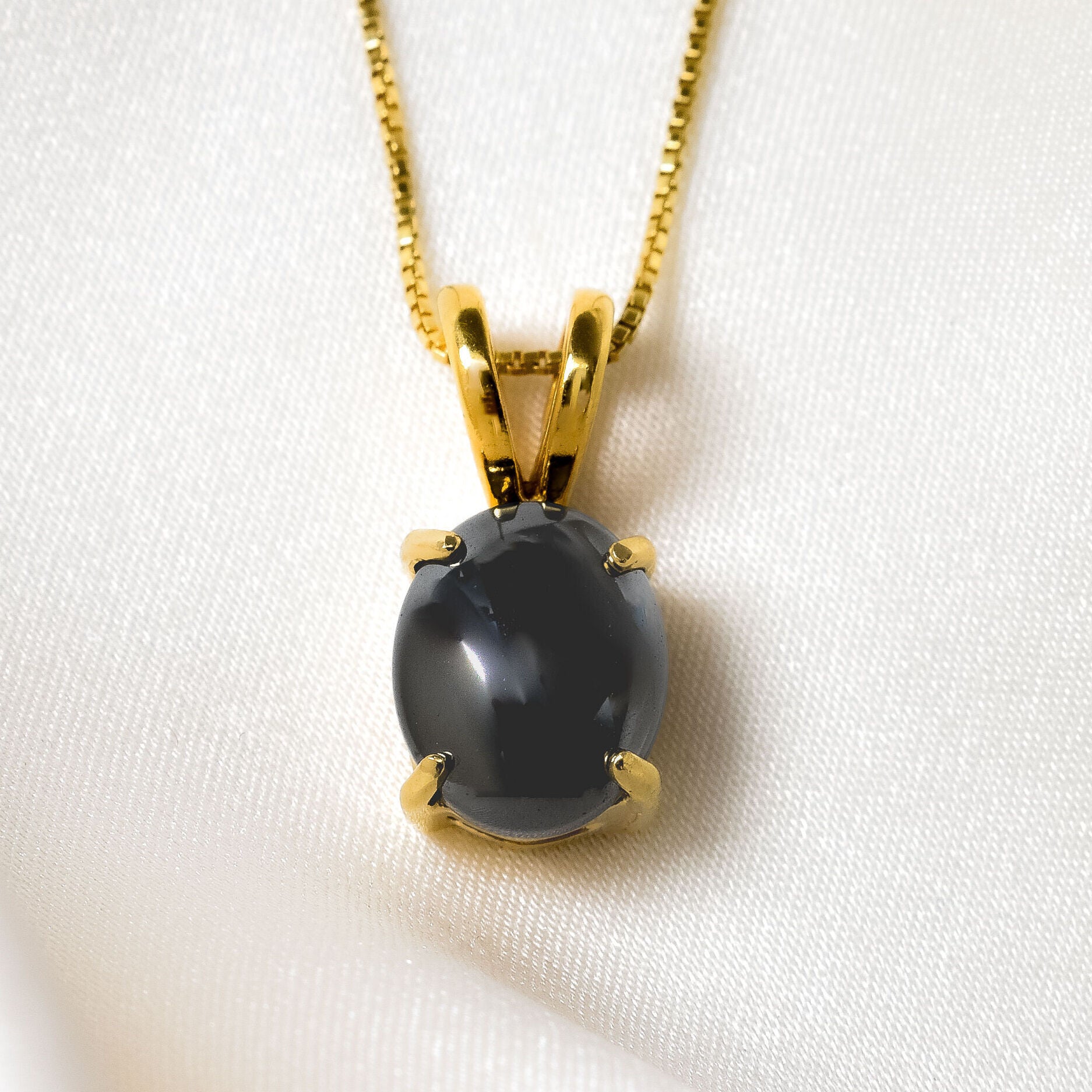 Natural Black Hematite necklace in 18k yellow gold over solid 925 sterling silver, in a cabochon cut, and prong setting. Solitaire gemstone perfect as a power statement necklace for formal wear and special occasions. Hematite symbolizes grounding, protection, and stability, making it a powerful stone for enhancing mental clarity and emotional well-being.