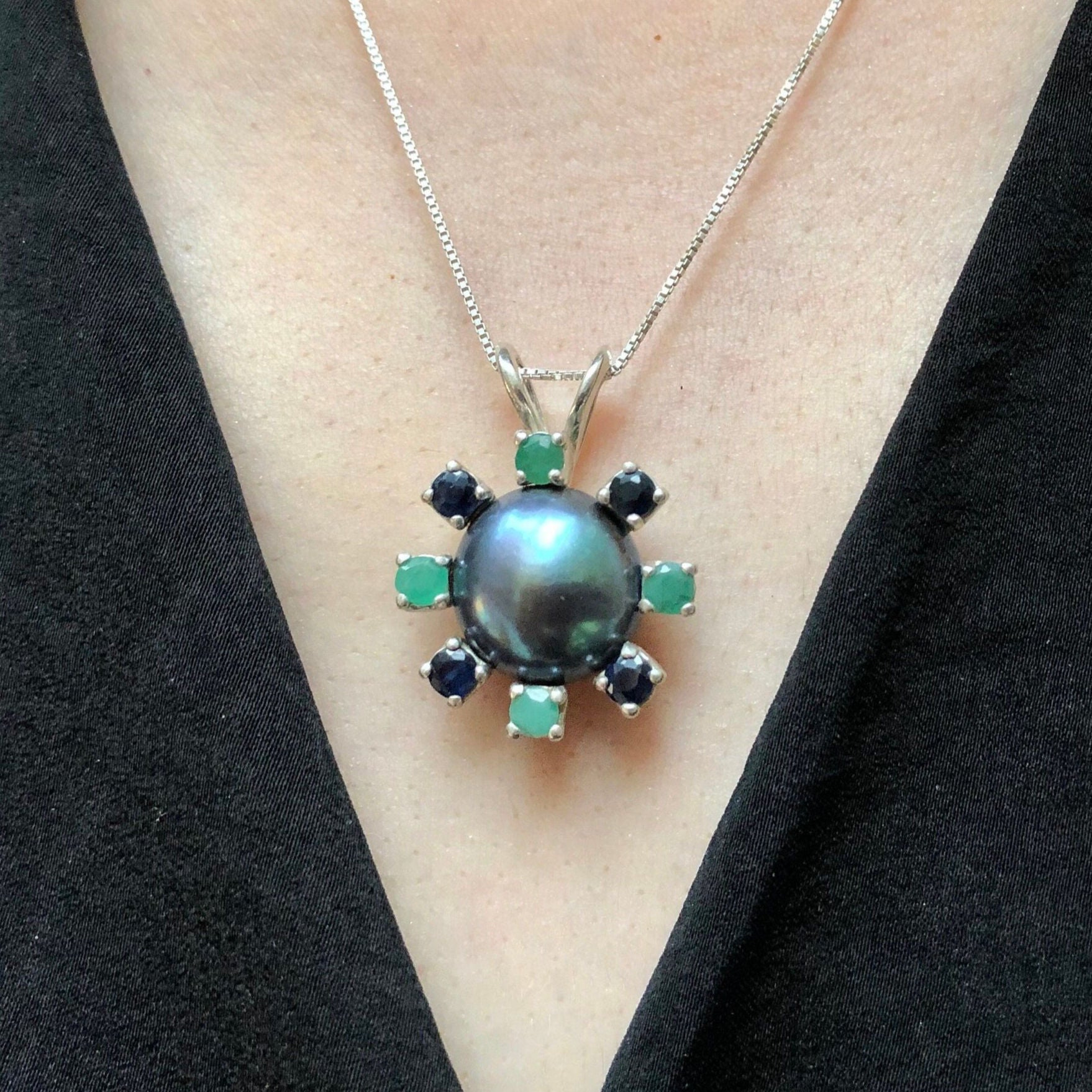 Black Pearl pendant in a classic jewelry style with Emerald and Sapphire